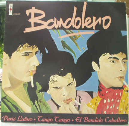 Photographie de la pochette recto du Disque vinyle Maxi Single 45 tours du groupe de musique franais form par Jill Merme-Bourezak et les Perez Brothers (Carlos et Jos): Bandolero - Paris Latino - Tango Tango - El Bandido Caballero - 1983 Virgin - Alexis Quinlin : Manager (Manager de Taxi-Girl) - Prix estimations cote de disques Vinyls Remix Club Dub Tubes Hits Funk Disco Rap Latino Dance (One-Hit Wonder) Chanson Franaise des annes 80 - Vinyleticketomania